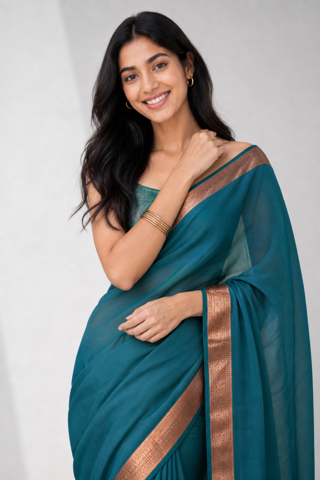Young woman in a teal silk saree